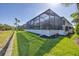 Spacious backyard featuring a screened pool enclosure and well-manicured lawn at 6228 Champions Row St, Bradenton, FL 34210