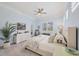 Light-filled bedroom with neutral walls, shutters, ceiling fan, and comfortable furnishings at 6228 Champions Row St, Bradenton, FL 34210