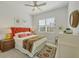 Cozy bedroom with a decorative rug, throw pillows, and natural light at 6228 Champions Row St, Bradenton, FL 34210