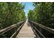 Picturesque boardwalk path through lush greenery leading towards a stunning view of the water at 6228 Champions Row St, Bradenton, FL 34210