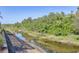 A canal with lush greenery on either side at 6228 Champions Row St, Bradenton, FL 34210