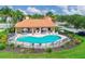 Beautiful community pool area with lounge seating, shaded tables, and inviting turquoise water at 6228 Champions Row St, Bradenton, FL 34210