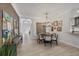 Formal dining room with decorative chandelier, designer rug, and entry view at 6228 Champions Row St, Bradenton, FL 34210