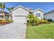 A beautiful single-Gathering home with a lush green lawn and mature landscaping at 6228 Champions Row St, Bradenton, FL 34210