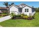Charming single-Gathering home featuring a well-manicured lawn, and a driveway leading to the garage at 6228 Champions Row St, Bradenton, FL 34210