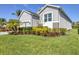Manicured landscaping and healthy green grass in the front yard add to the curb appeal of this home at 6228 Champions Row St, Bradenton, FL 34210