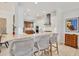 Bright, modern kitchen features white cabinetry, marble countertops, and a stylish breakfast bar at 6228 Champions Row St, Bradenton, FL 34210