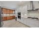 Modern kitchen with stainless steel appliances, tile backsplash, gas range, and a combination of white and wood cabinets at 6228 Champions Row St, Bradenton, FL 34210