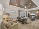 Relaxing living room featuring wood-look ceiling, neutral furniture, and a decorative accent wall at 6228 Champions Row St, Bradenton, FL 34210