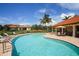 Gorgeous swimming pool surrounded by lounge chairs and lush landscaping for relaxation and leisure at 6228 Champions Row St, Bradenton, FL 34210