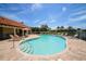 Community pool with seating, umbrella, and beautiful surroundings at 6228 Champions Row St, Bradenton, FL 34210