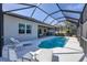 Stunning pool area with outdoor seating, sun loungers, and screened enclosure at 6228 Champions Row St, Bradenton, FL 34210