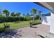 Landscaped backyard showcasing a beautiful lawn and tropical palm trees, perfect for relaxing in the Florida sunshine at 6308 Plateau Ct, Bradenton, FL 34203