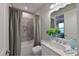 Well-lit bathroom with a shower-tub combo, bright light fixtures, and a decorative plant for added style at 6308 Plateau Ct, Bradenton, FL 34203