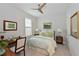 Cozy bedroom showcasing a ceiling fan, warm light fixtures, and a relaxing reading area with a desk at 6308 Plateau Ct, Bradenton, FL 34203