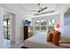 Well-lit bedroom features palm tree views from the window, a ceiling fan, and warm, inviting colors at 6308 Plateau Ct, Bradenton, FL 34203