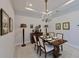 Elegant dining room features a chandelier, decorative furnishings, and a classic wooden table with seating for four at 6308 Plateau Ct, Bradenton, FL 34203