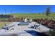 Cozy outdoor fire pit with comfortable seating and a beautiful green space backdrop at 6308 Plateau Ct, Bradenton, FL 34203