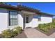 Charming home featuring a tiled roof, white exterior, and a welcoming covered front entry with lush landscaping at 6308 Plateau Ct, Bradenton, FL 34203