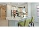 Beautiful kitchen with white countertops, stainless steel appliances, and a convenient breakfast bar with green stools at 6308 Plateau Ct, Bradenton, FL 34203