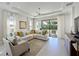Bright living room with tile floors, a ceiling fan, and large windows that provide plenty of natural light at 6308 Plateau Ct, Bradenton, FL 34203