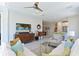 Inviting living room with tile floors, comfortable seating, and an open view of the dining area and kitchen at 6308 Plateau Ct, Bradenton, FL 34203