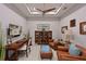 Comfortable living room features a desk, armchairs, hardwood floors, and a ceiling fan at 6308 Plateau Ct, Bradenton, FL 34203