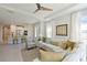 Open-concept living room with a view of the kitchen, complete with tile floors and modern furnishings at 6308 Plateau Ct, Bradenton, FL 34203