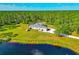 Aerial view featuring home with expansive yard and pond surrounded by mature trees at 6407 213Th E St, Bradenton, FL 34211