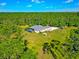 Aerial view showcasing the beautiful home and large lot bordered by mature trees at 6407 213Th E St, Bradenton, FL 34211