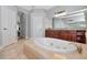 Bright bathroom featuring a large soaking tub and wooden cabinets with granite countertops at 6407 213Th E St, Bradenton, FL 34211