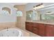 Bright and spacious bathroom features a soaking tub and dual vanities at 6407 213Th E St, Bradenton, FL 34211