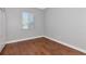 Bedroom with hardwood floors, a window and an open closet enhancing the space at 6407 213Th E St, Bradenton, FL 34211