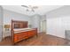 Bedroom with hardwood floors and a large bed with an open closet enhancing the space at 6407 213Th E St, Bradenton, FL 34211