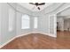 Bedroom featuring hardwood floors, arched windows, french doors, and ceiling fan at 6407 213Th E St, Bradenton, FL 34211