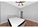 Bedroom featuring hardwood floors, a modern bed, and a ceiling fan providing comfort at 6407 213Th E St, Bradenton, FL 34211