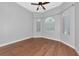 Bedroom featuring hardwood floors, arched windows with blinds, and ceiling fan at 6407 213Th E St, Bradenton, FL 34211