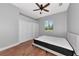 Bright bedroom with hardwood floors, a black bed, and a window letting in natural light at 6407 213Th E St, Bradenton, FL 34211