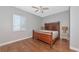 Bedroom with hardwood floors, a window, and a wooden bed frame, creating a cozy atmosphere at 6407 213Th E St, Bradenton, FL 34211