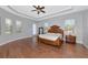 Large primary bedroom features wood floors, tray ceiling, and lots of natural light at 6407 213Th E St, Bradenton, FL 34211