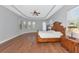 Spacious primary bedroom features a tray ceiling, wood floors, and lots of natural light at 6407 213Th E St, Bradenton, FL 34211
