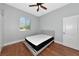 Bedroom featuring hardwood floors, a light-colored bed frame, and a window at 6407 213Th E St, Bradenton, FL 34211