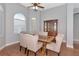 Dining room featuring a wood table, six chairs, hardwood floors, and ample natural light at 6407 213Th E St, Bradenton, FL 34211