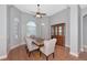 Dining room with a wood table, six chairs, hardwood floor, and ceiling fan at 6407 213Th E St, Bradenton, FL 34211