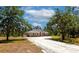 Charming single-story home with a circular driveway and beautiful landscaping at 6407 213Th E St, Bradenton, FL 34211