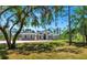 Inviting home exterior with well-manicured lawn and mature trees providing shade at 6407 213Th E St, Bradenton, FL 34211
