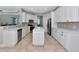 Contemporary kitchen featuring bright white cabinets, stainless steel appliances, and an island at 6407 213Th E St, Bradenton, FL 34211
