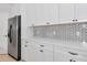 Bright kitchen with white cabinets, light countertops, and stainless steel refrigerator at 6407 213Th E St, Bradenton, FL 34211