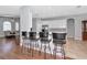 Open concept kitchen with counter seating featuring bright white cabinetry and stainless steel appliances at 6407 213Th E St, Bradenton, FL 34211