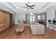 Spacious open-concept living room boasts wood floors and abundant natural light, perfect for entertaining at 6407 213Th E St, Bradenton, FL 34211